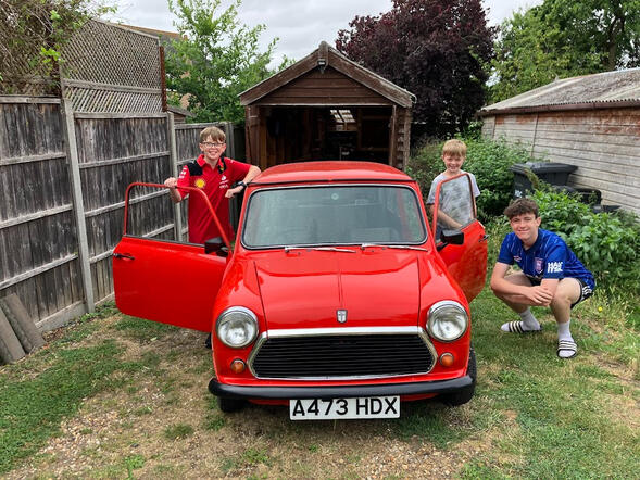 After a long wait for repairs to be completed, in Summer 2024 the Mini returned home - pictured here with the fourth generation of family to call it Bessie.